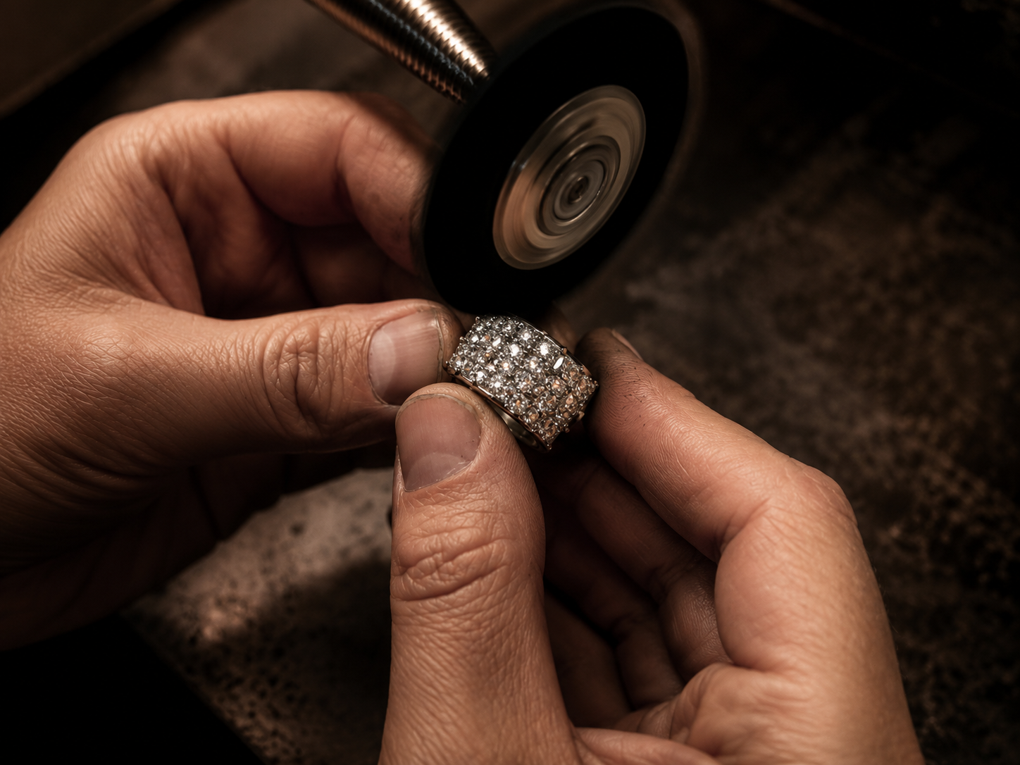 Jeweller working on a detailed piece at the bench
